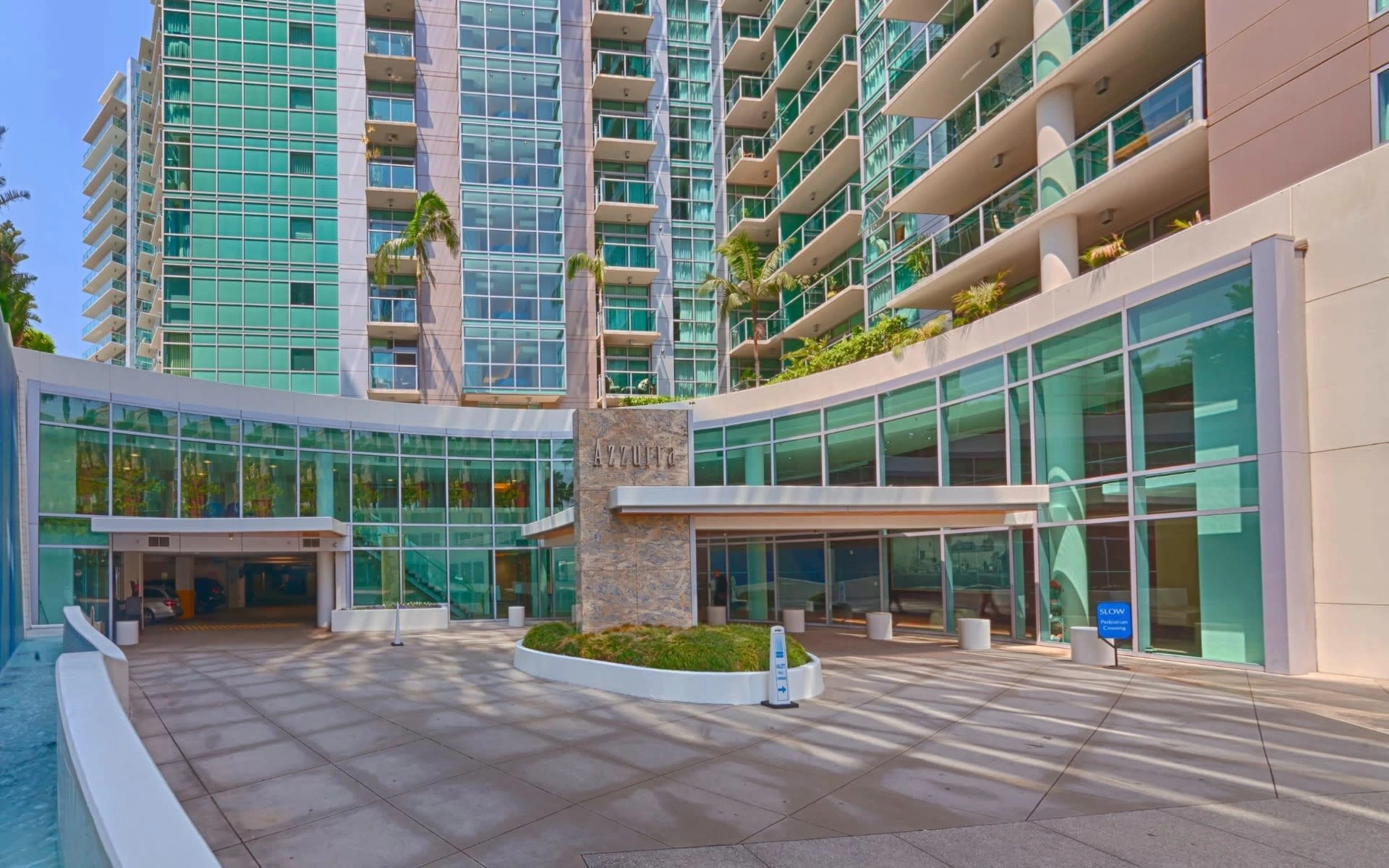 The sweeping glass facade and entrance of Azzurra in Marina del Rey